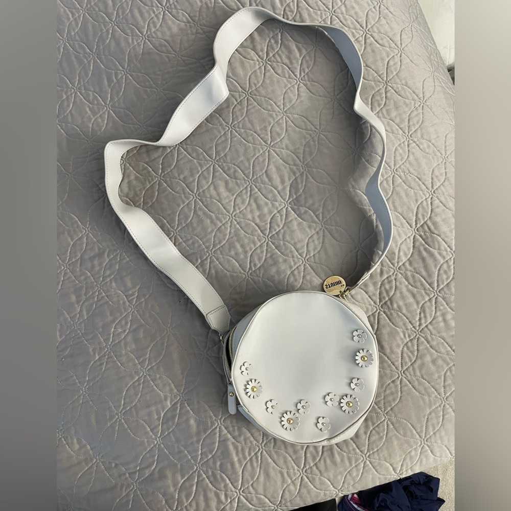 Round crossbody bag with floral embellishment